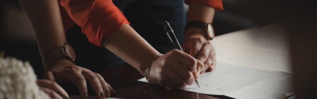 People signing papers