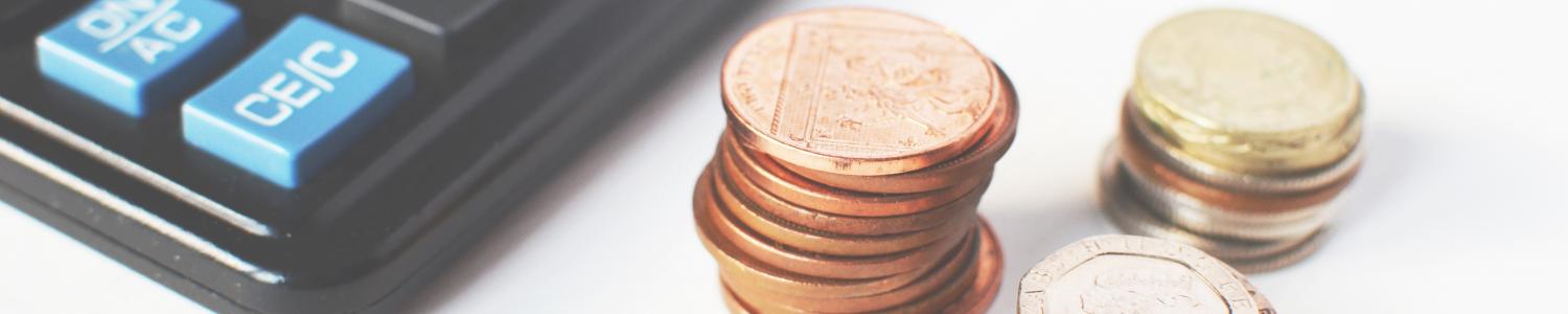 calculator and stacks of coins